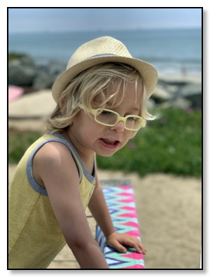 Arrow at beach with hat June 2020
