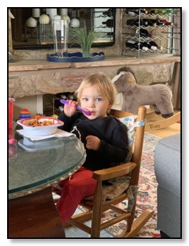 Azelle eating with her spoon May 2020